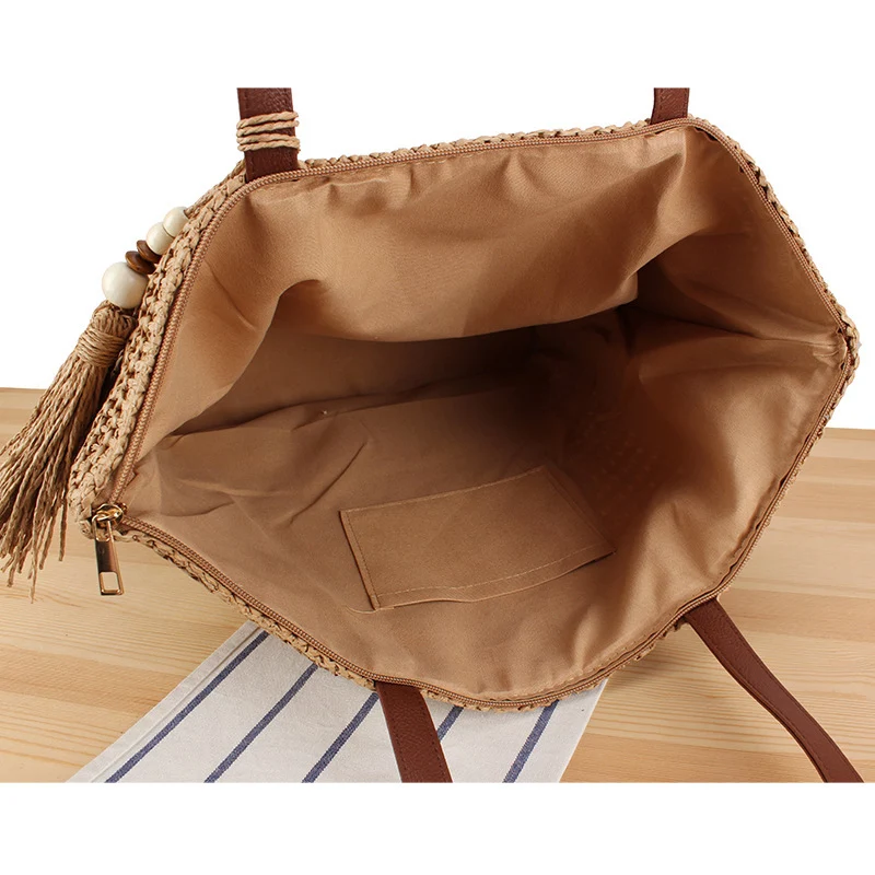 Handtasche aus geflochtenem Naturmaterial mit Quasten-Dekoration Skanto